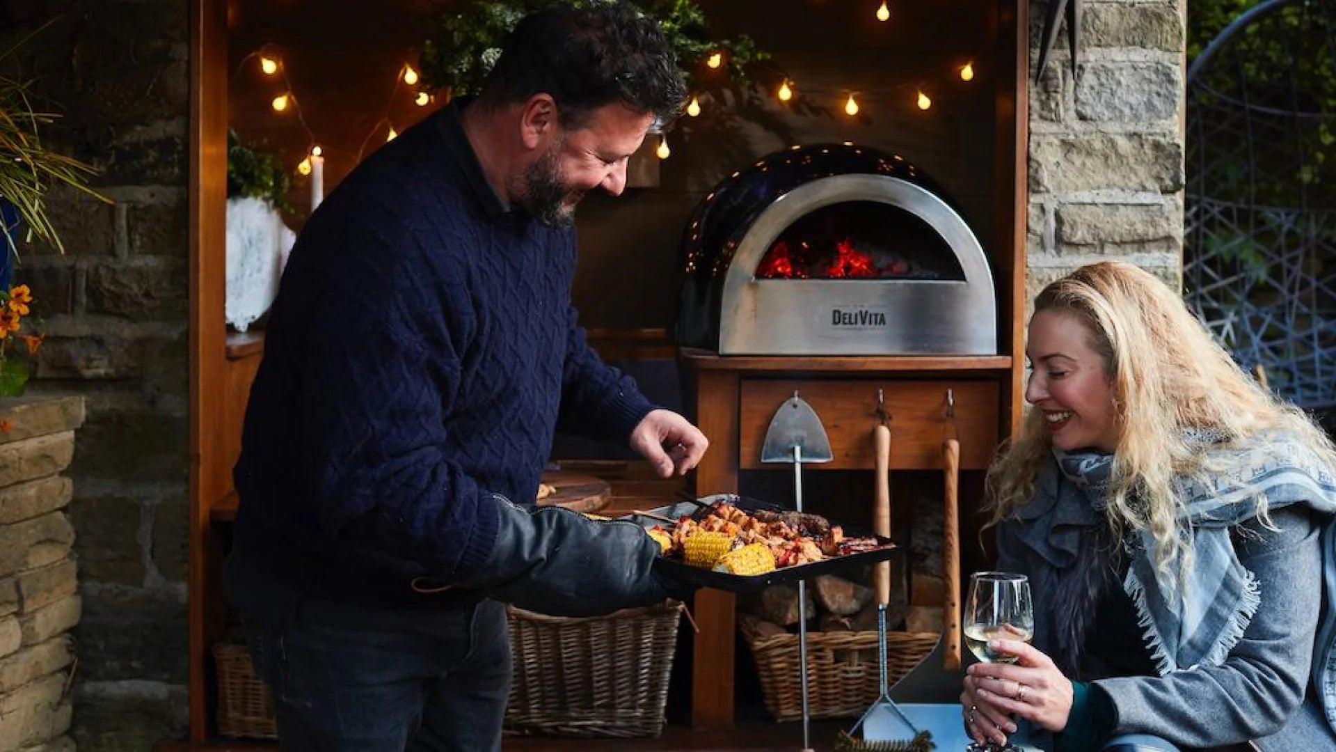 two people showing food cooked-in-a-delivita-pizza-oven
